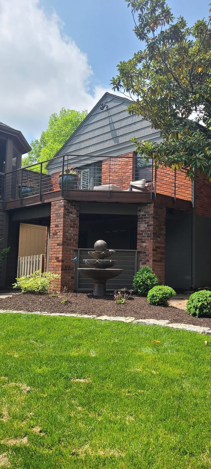 Modern home exterior with the restored deck above
