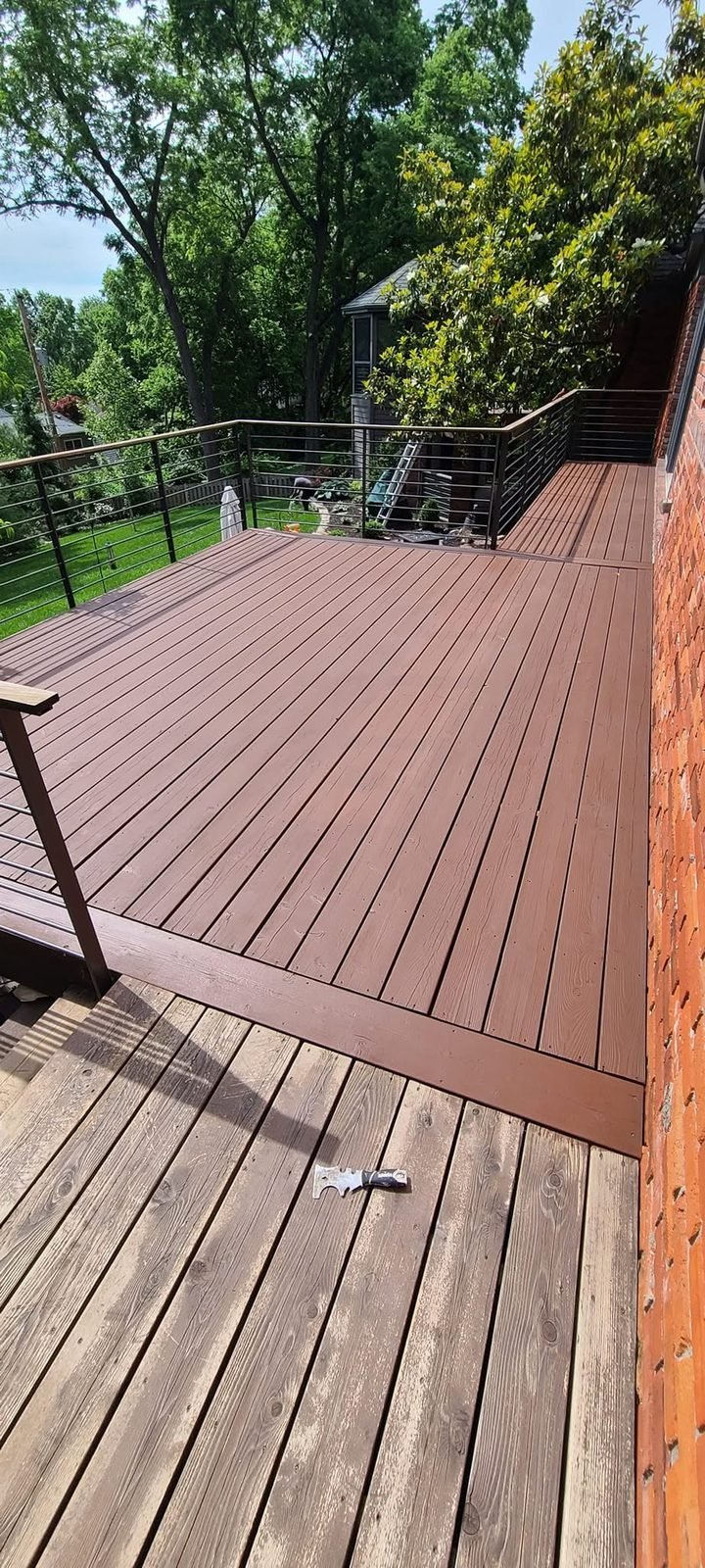 Deck half stained, weathered boards beside fresh stain