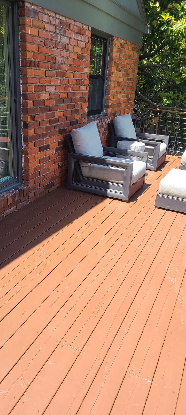 Deck seating area beside brick after staining