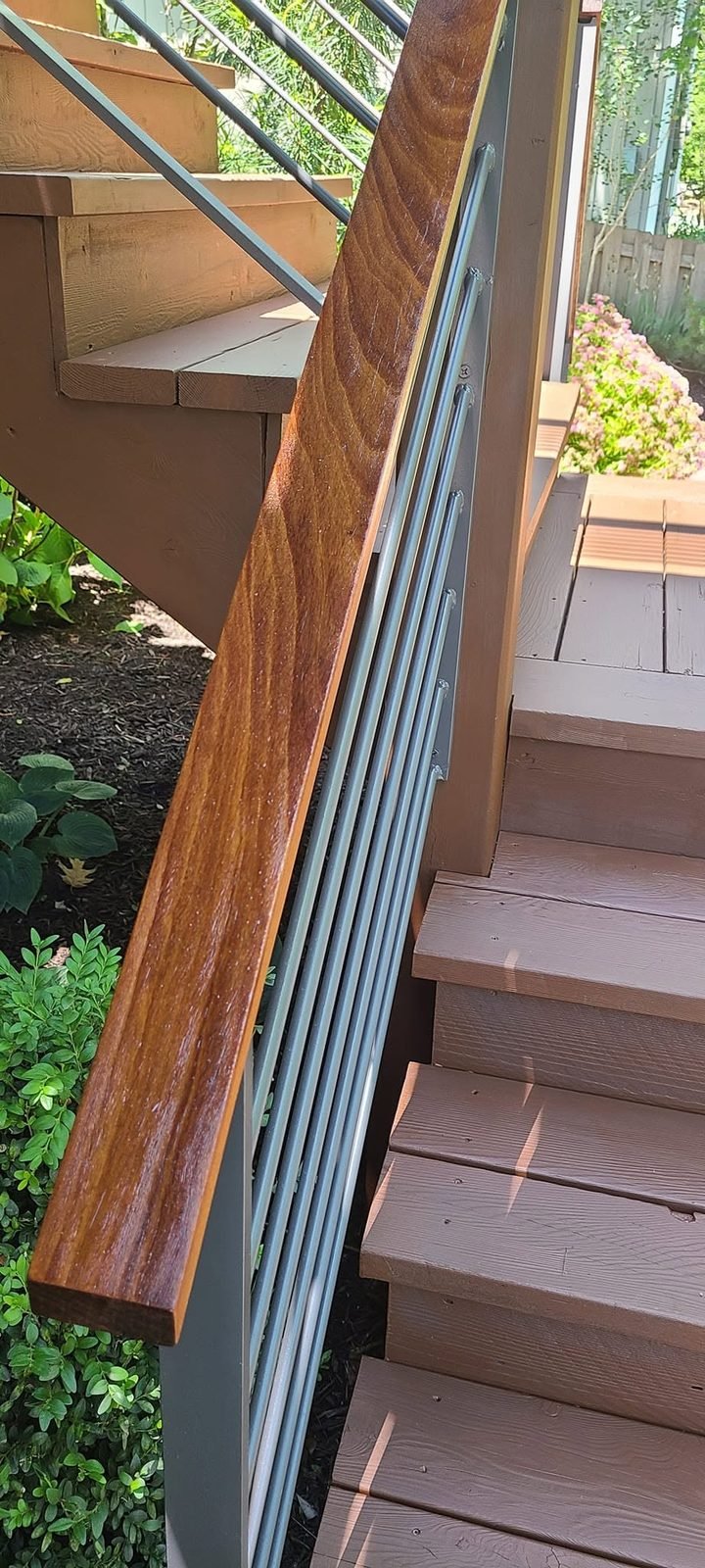 Refinished mahogany handrail with cable railing