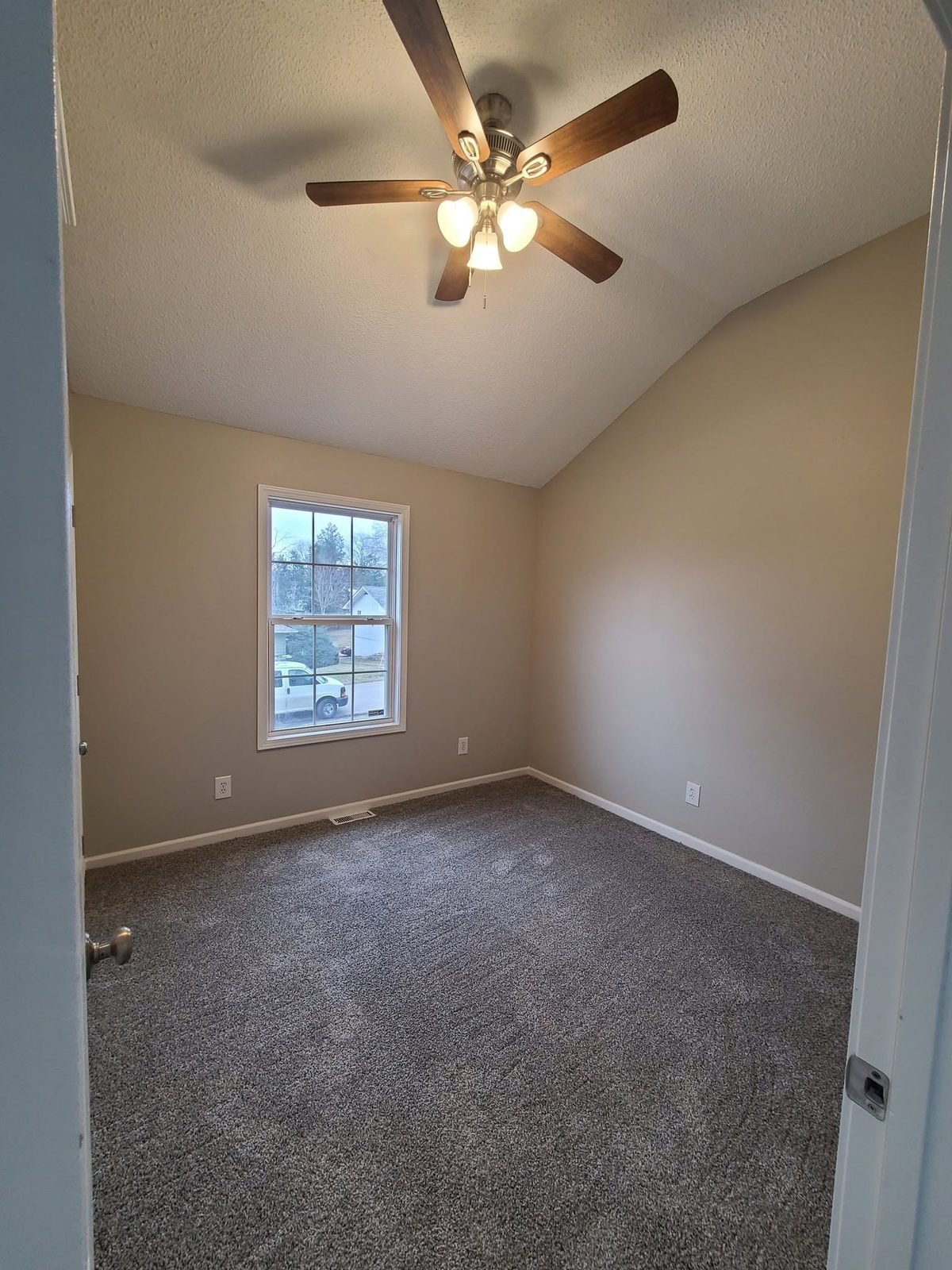 Bedroom with ceiling fan and new carpet