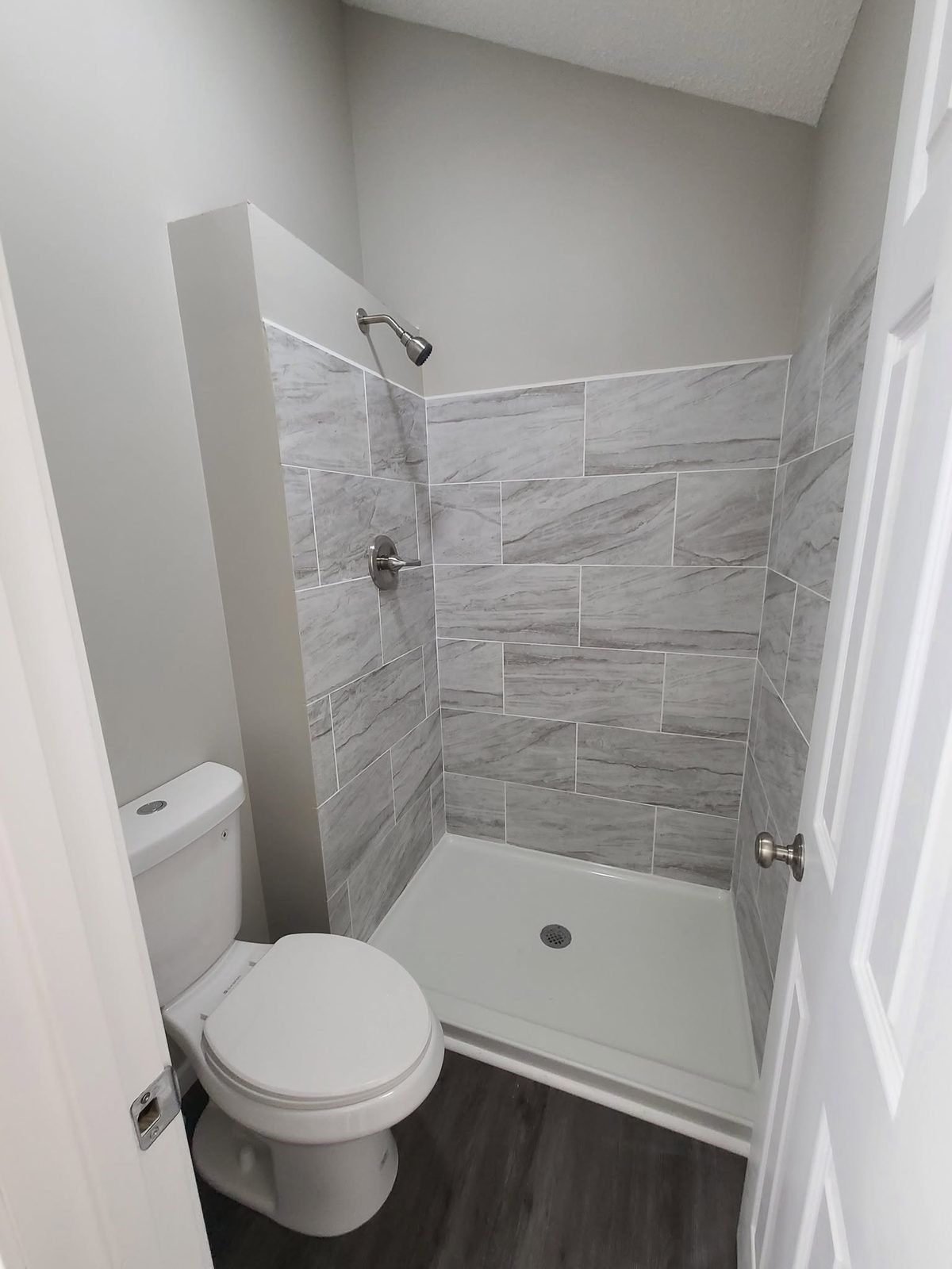 New walk-in shower with custom tile surround