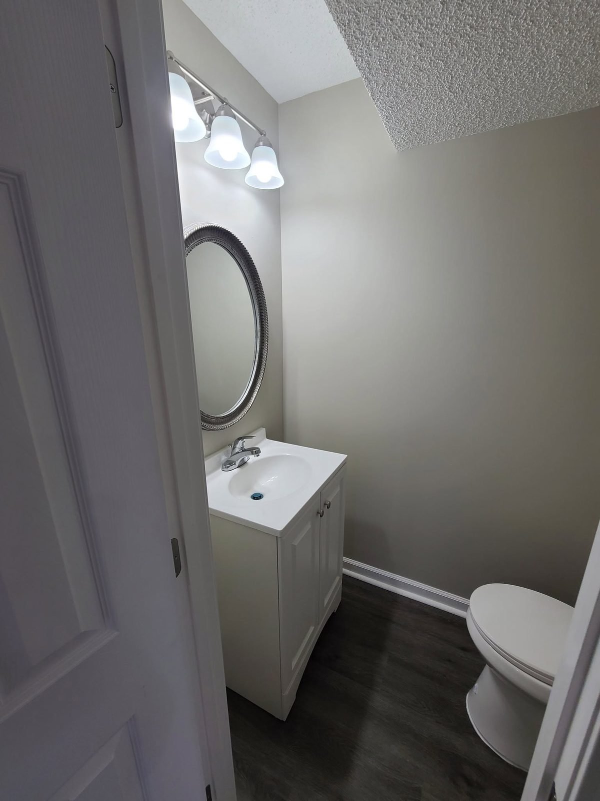 Half bath with new vanity and mirror