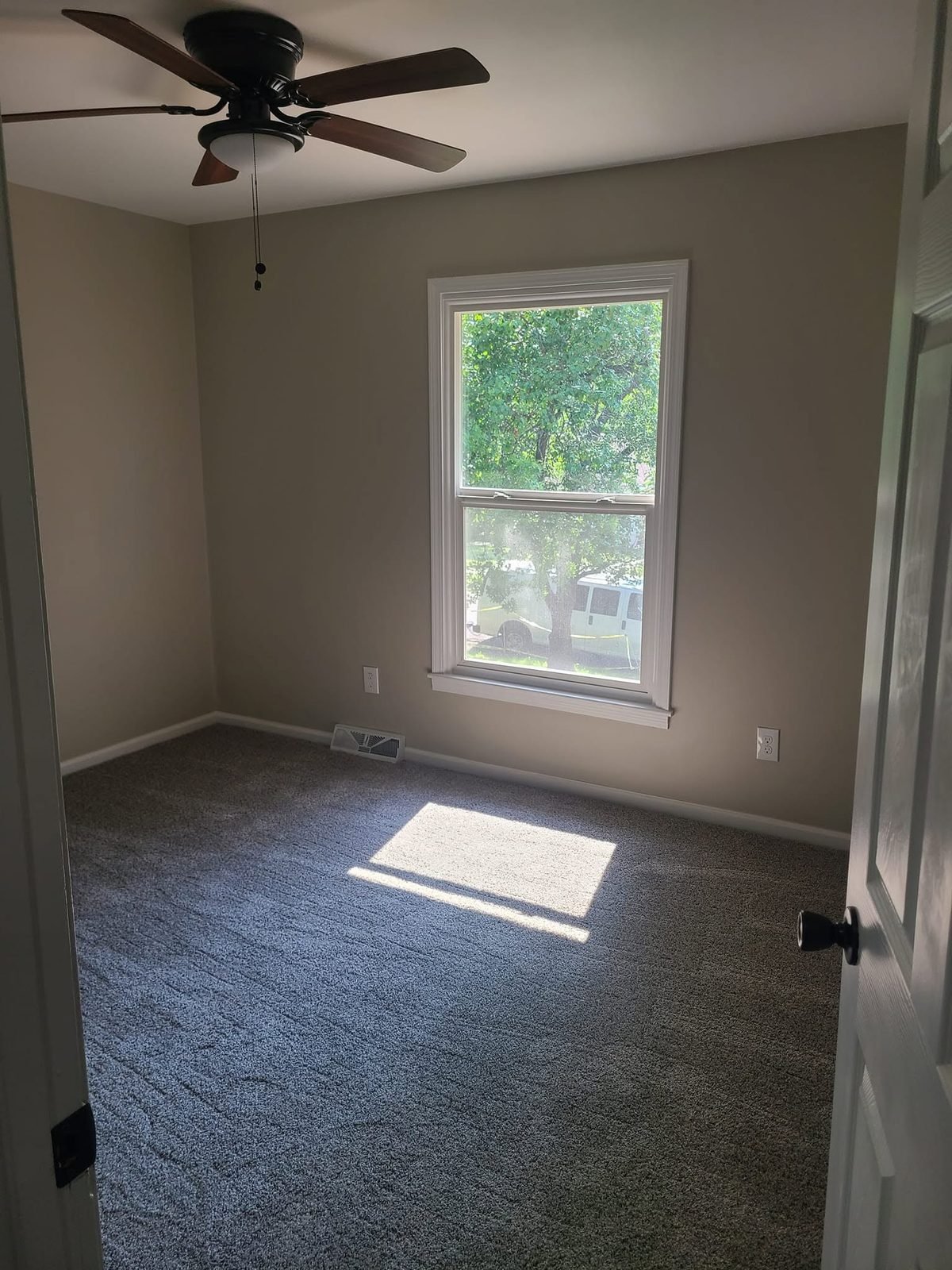 Bedroom with ceiling fan and new carpet