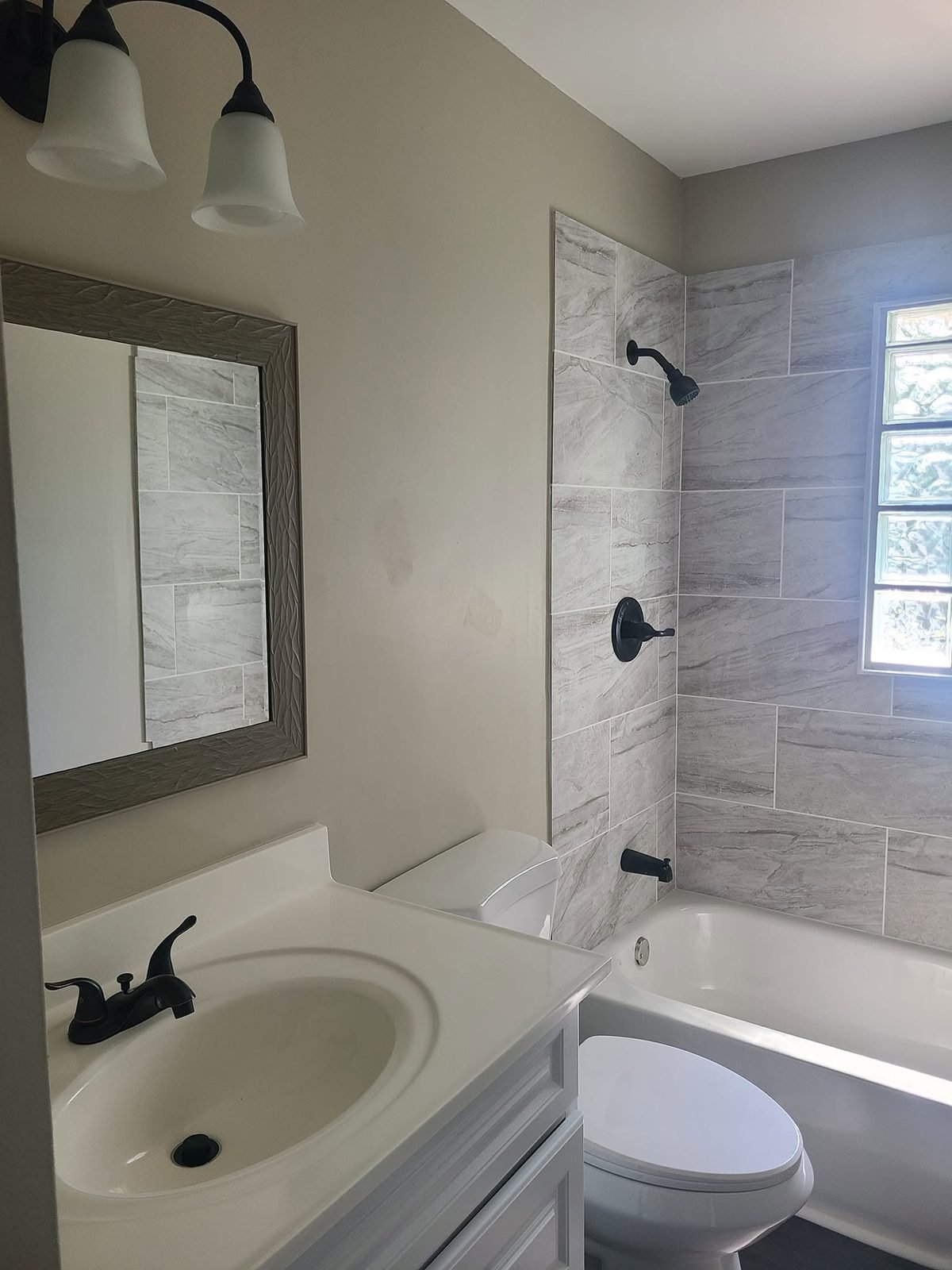 Bathroom with new vanity and tiled tub